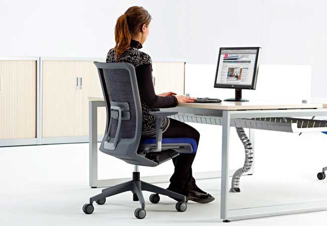 Illustration of an ergonomic workspace consultation with desk and seating arrangement