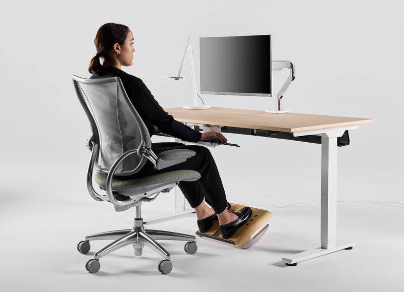 Visual guide showing proper desk setup with monitor, keyboard, and chair positioning